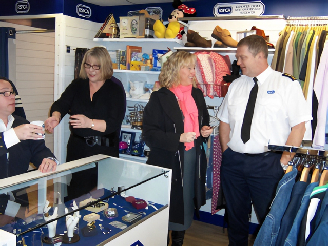 A photo four people standing and talking in the RSPCA Newmarket charity shop